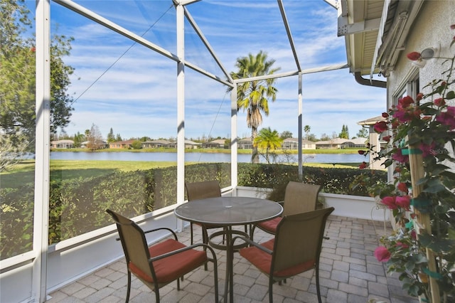 sunroom / solarium with a water view