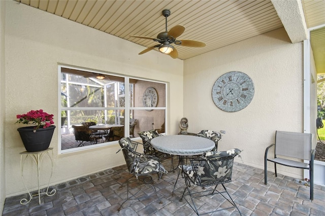 view of patio / terrace featuring ceiling fan and a lanai