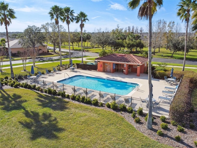 view of swimming pool with a yard and a patio