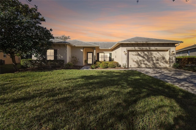 view of front of property with a lawn and a garage