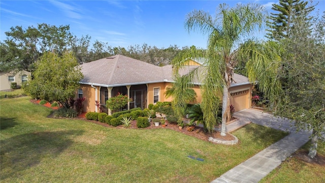 view of front facade with a garage and a front lawn