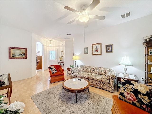 tiled living room with ceiling fan