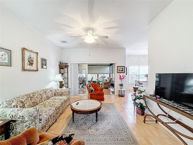 living room with ceiling fan and light tile patterned flooring