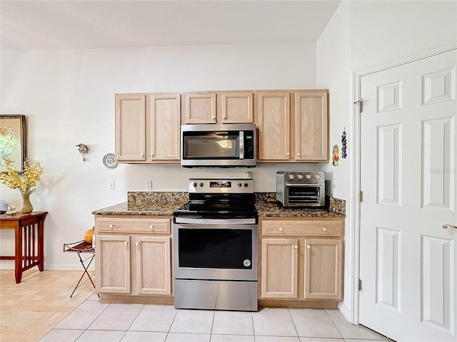 kitchen featuring light brown cabinetry, light tile patterned floors, and appliances with stainless steel finishes