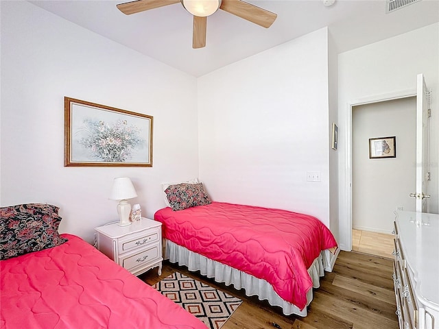 bedroom featuring ceiling fan and dark hardwood / wood-style flooring