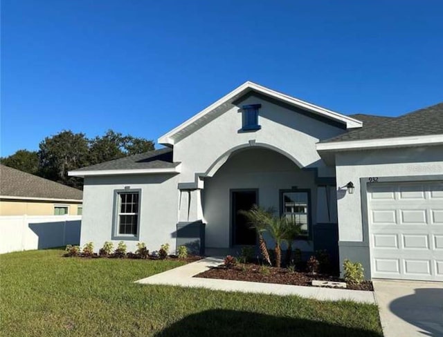 view of front of home featuring a front lawn and a garage