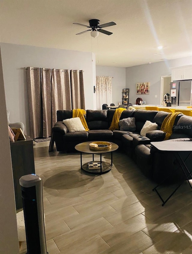 living room featuring ceiling fan and light wood-type flooring