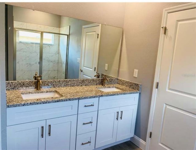 bathroom featuring vanity and a shower with shower door