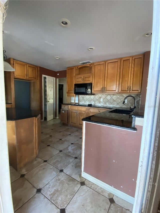 kitchen featuring tasteful backsplash and sink