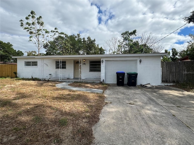 single story home with covered porch and a garage