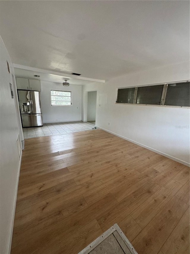 unfurnished living room with light hardwood / wood-style flooring