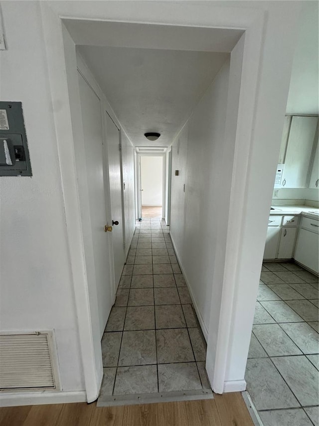 corridor with light tile patterned flooring