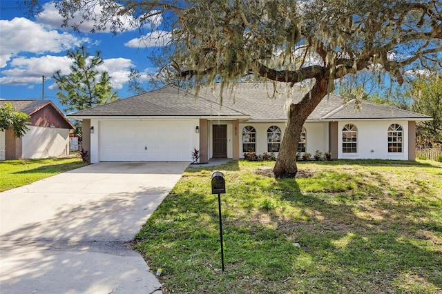 ranch-style house featuring a front lawn and a garage