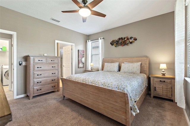 carpeted bedroom featuring ceiling fan and washer / clothes dryer