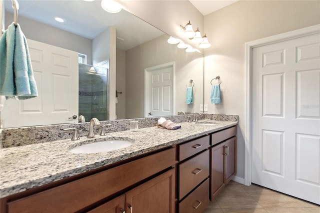 bathroom featuring a shower, vanity, and tile patterned floors