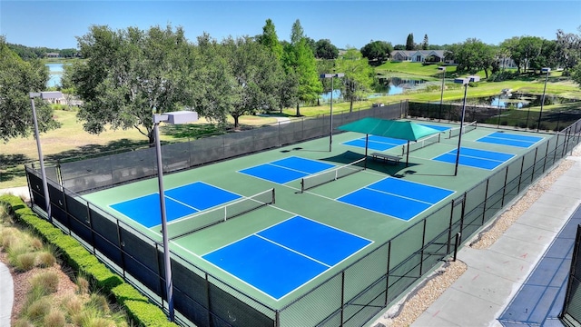 view of sport court featuring basketball court and a water view