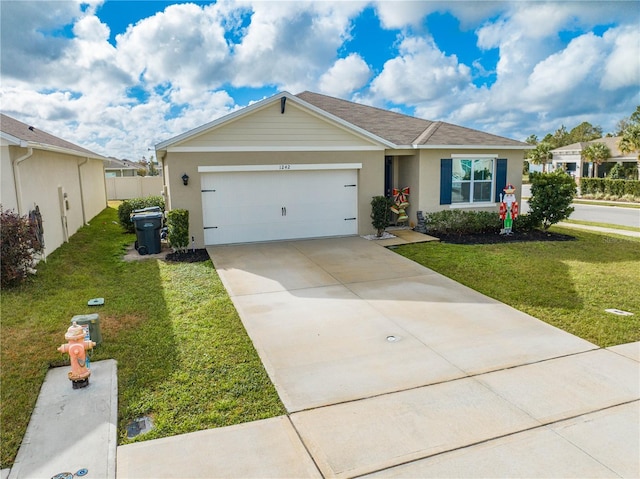 single story home featuring a garage and a front yard