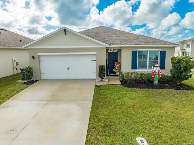 ranch-style home featuring a garage and a front lawn