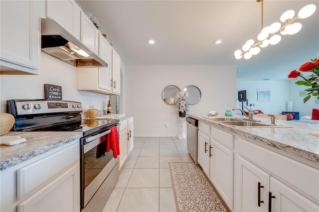 kitchen featuring appliances with stainless steel finishes, sink, light tile patterned floors, white cabinetry, and hanging light fixtures