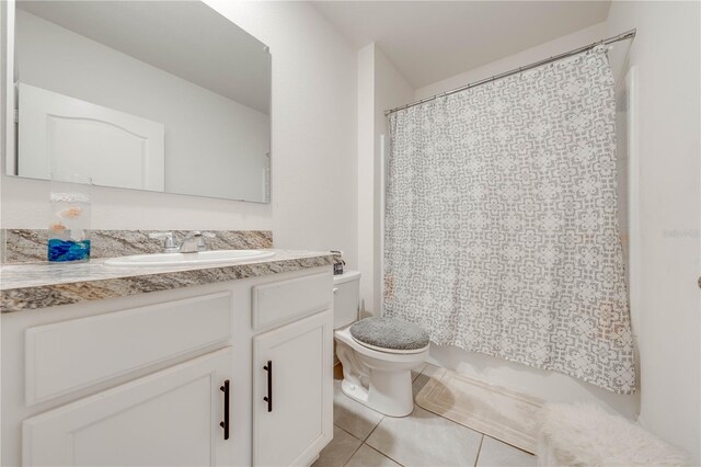 bathroom featuring tile patterned flooring, vanity, and toilet