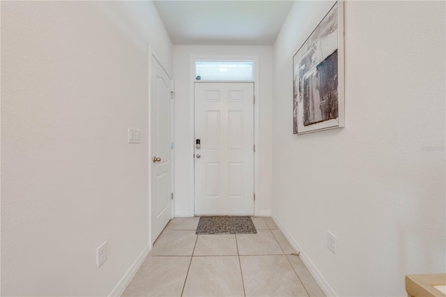 doorway to outside with light tile patterned floors