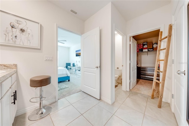 bathroom featuring tile patterned floors, vanity, and toilet