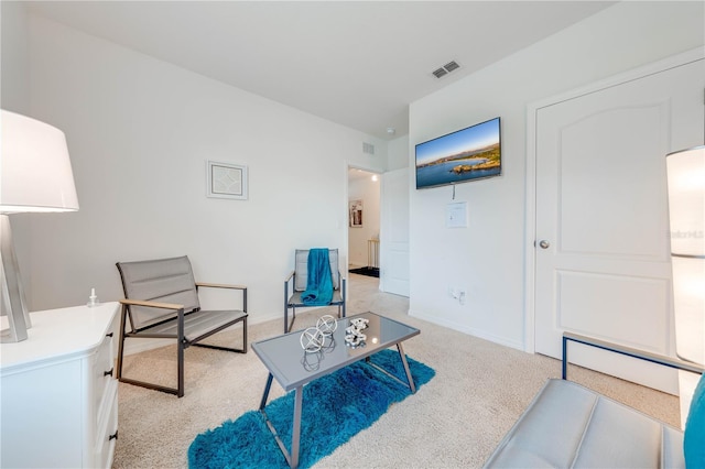 sitting room featuring light carpet