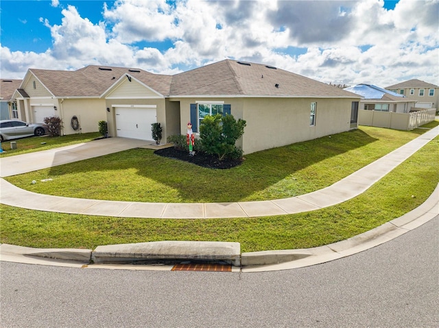 view of front of home featuring a front lawn and a garage