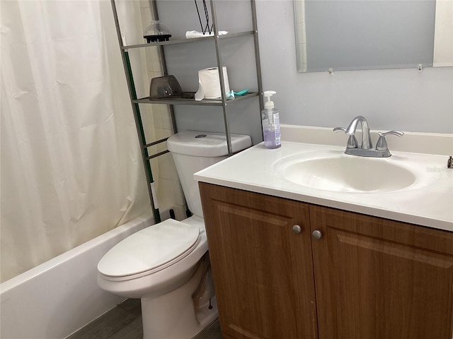 bathroom with shower / bath combo, vanity, and toilet