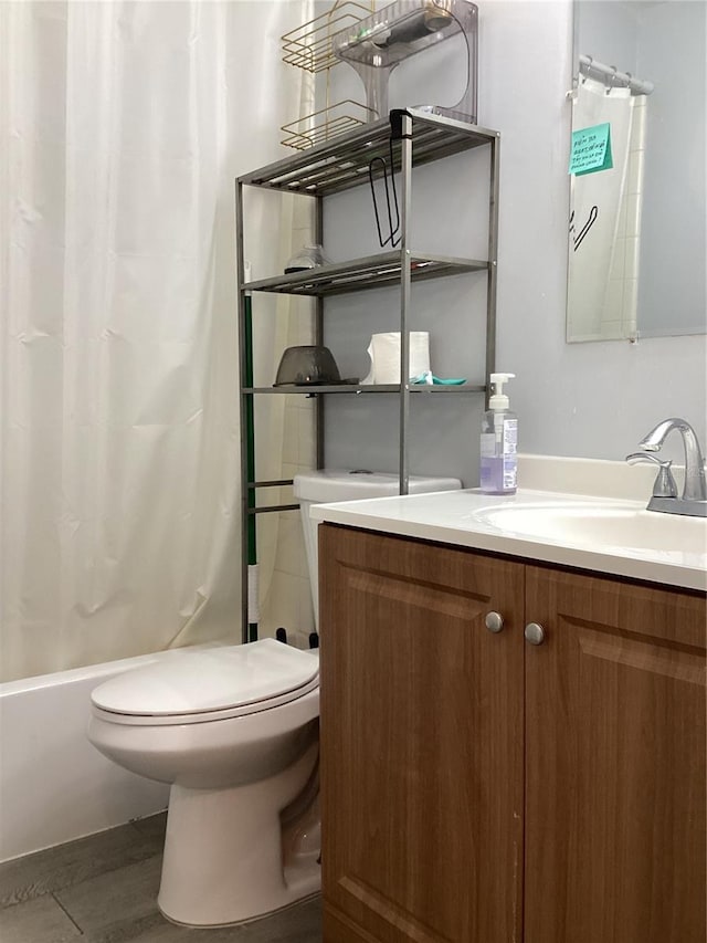 full bathroom featuring shower / tub combo, vanity, and toilet