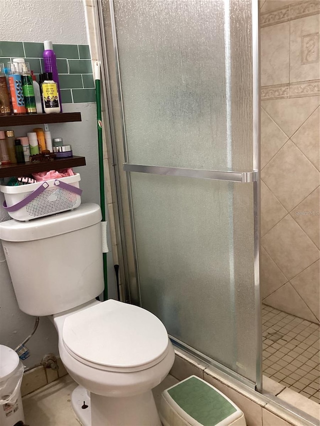 full bathroom with toilet and a stall shower