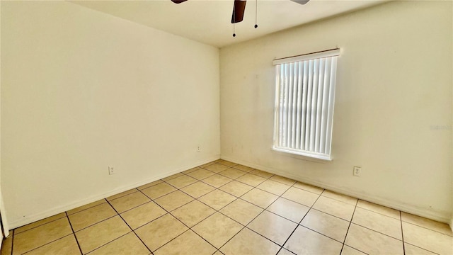 unfurnished room with a ceiling fan and light tile patterned floors