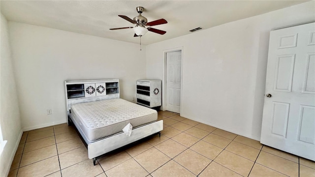 bedroom with light tile patterned floors, ceiling fan, and visible vents