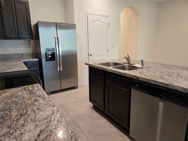 kitchen with light tile patterned flooring, sink, and stainless steel appliances