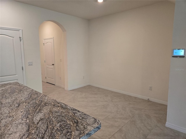 unfurnished bedroom with light tile patterned floors