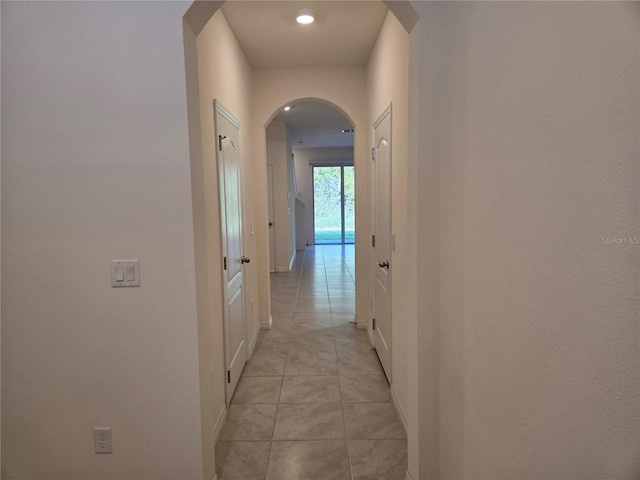 hall featuring light tile patterned floors