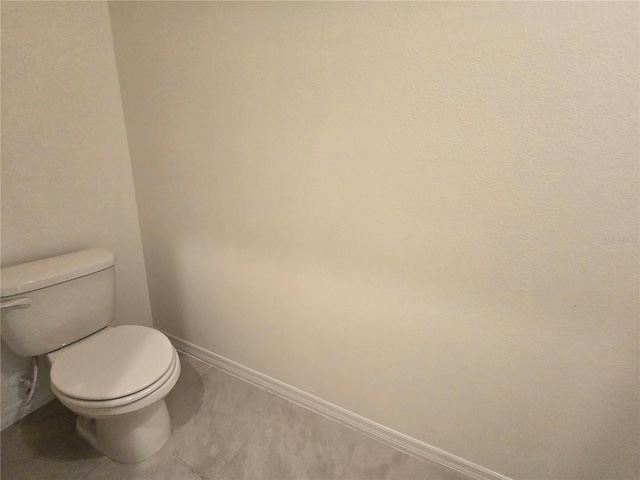 bathroom with tile patterned floors and toilet