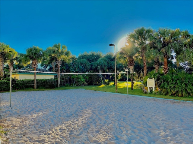 view of community with volleyball court and a yard