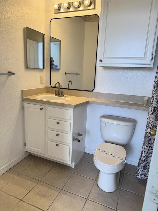 bathroom with tile patterned floors, vanity, and toilet