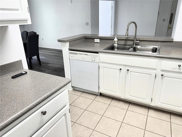 kitchen featuring white cabinetry, sink, white dishwasher, and light tile patterned floors