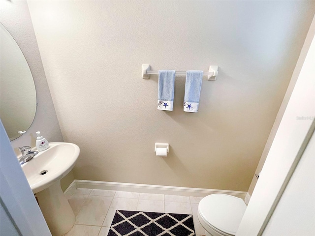 bathroom featuring tile patterned flooring and toilet