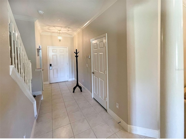 foyer featuring crown molding and light tile patterned floors