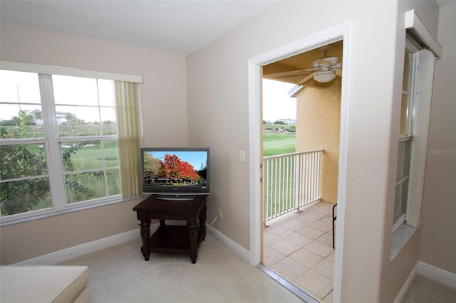 sitting room featuring ceiling fan and light colored carpet