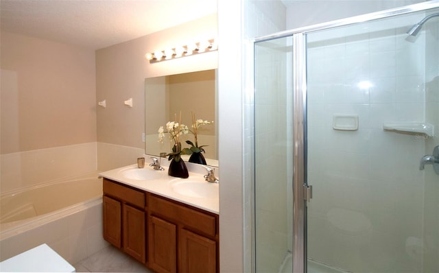 bathroom with plus walk in shower, vanity, and a textured ceiling