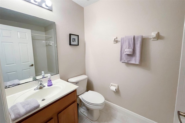 bathroom featuring tile patterned floors, a shower, vanity, and toilet