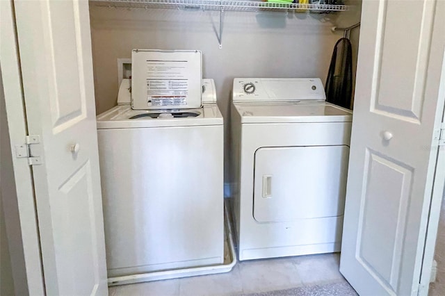 clothes washing area featuring washer and dryer