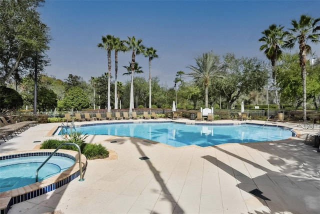 view of swimming pool with a patio area and a hot tub