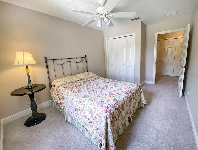 carpeted bedroom featuring ceiling fan and a closet