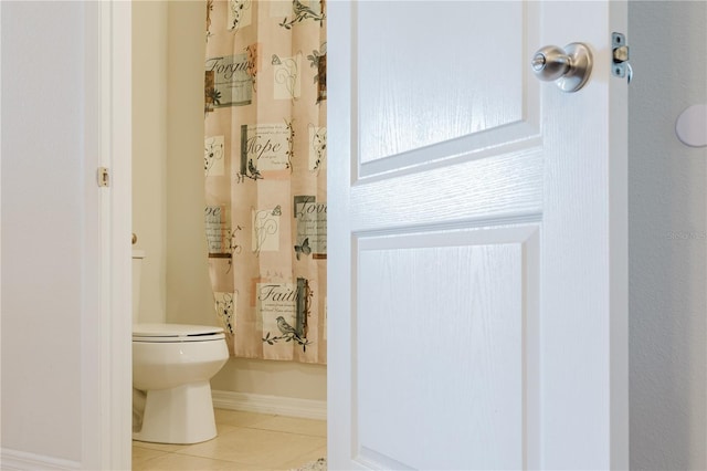 bathroom with tile patterned flooring and toilet