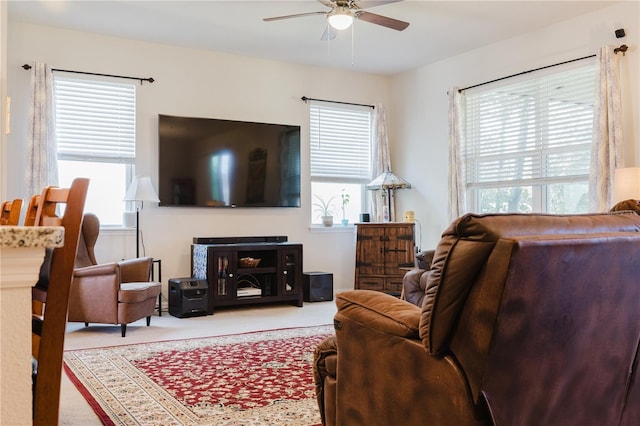 carpeted living room featuring a wealth of natural light and ceiling fan